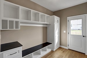 Mudroom with cabinets and shelving