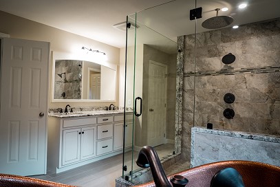 Bathroom with glass doors, vanity and sinks