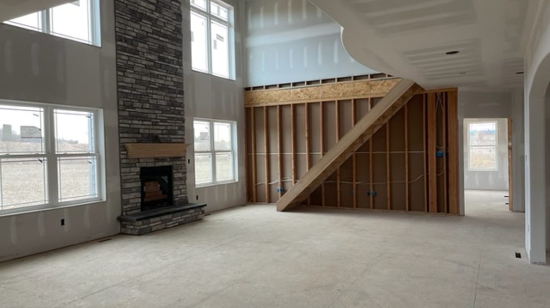 under construction, drywall finish, great room and fireplace